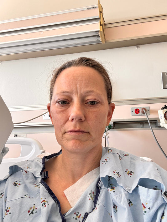 Shawna in a hospital gown, in a hospital just days after having surgery.